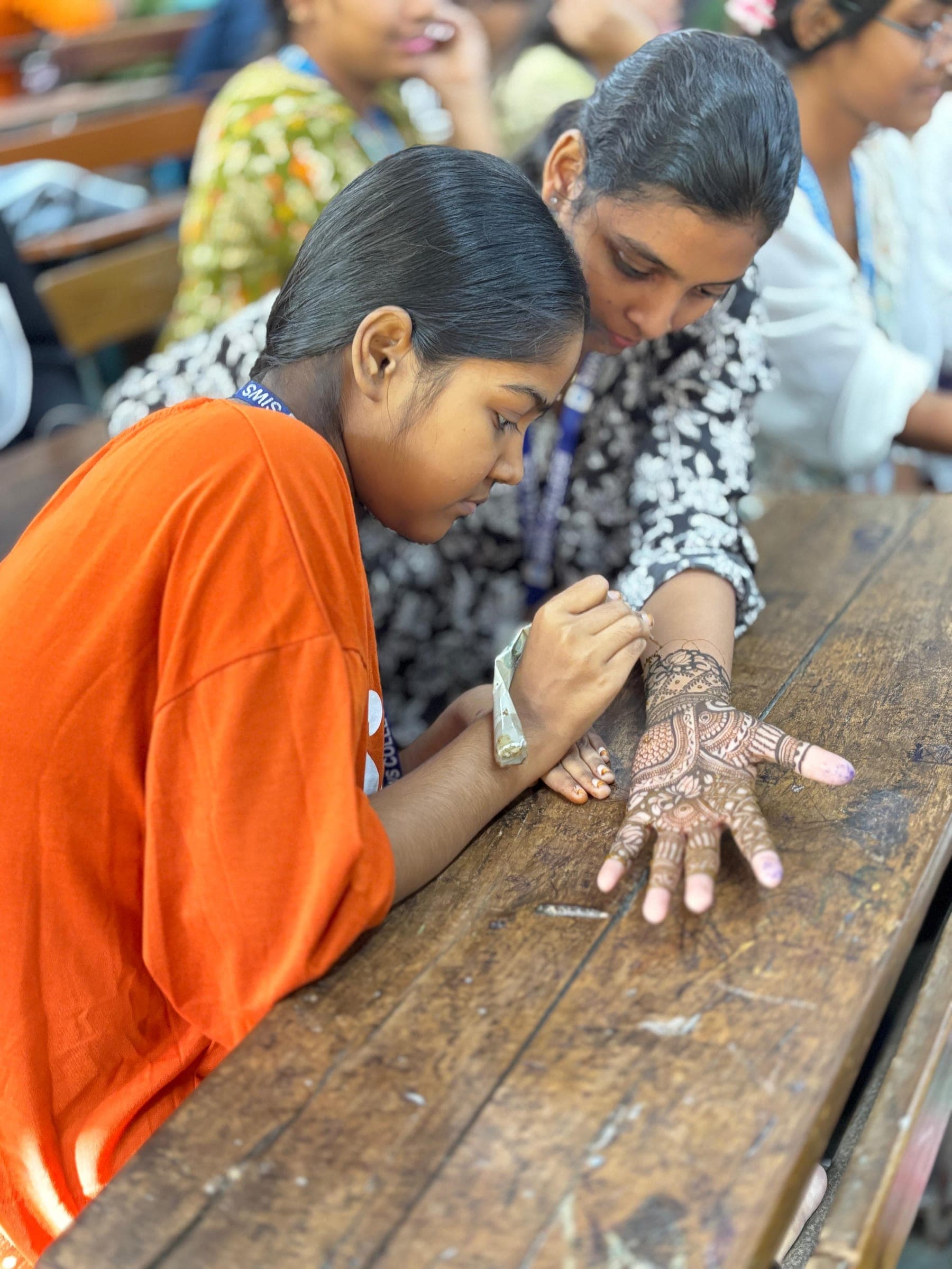 The mehendi competition, students at work on their designs.