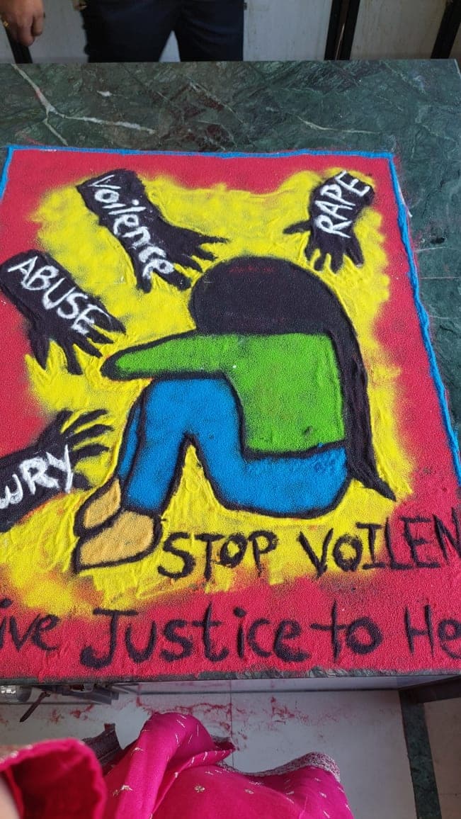 A second rangoli design laid by students.