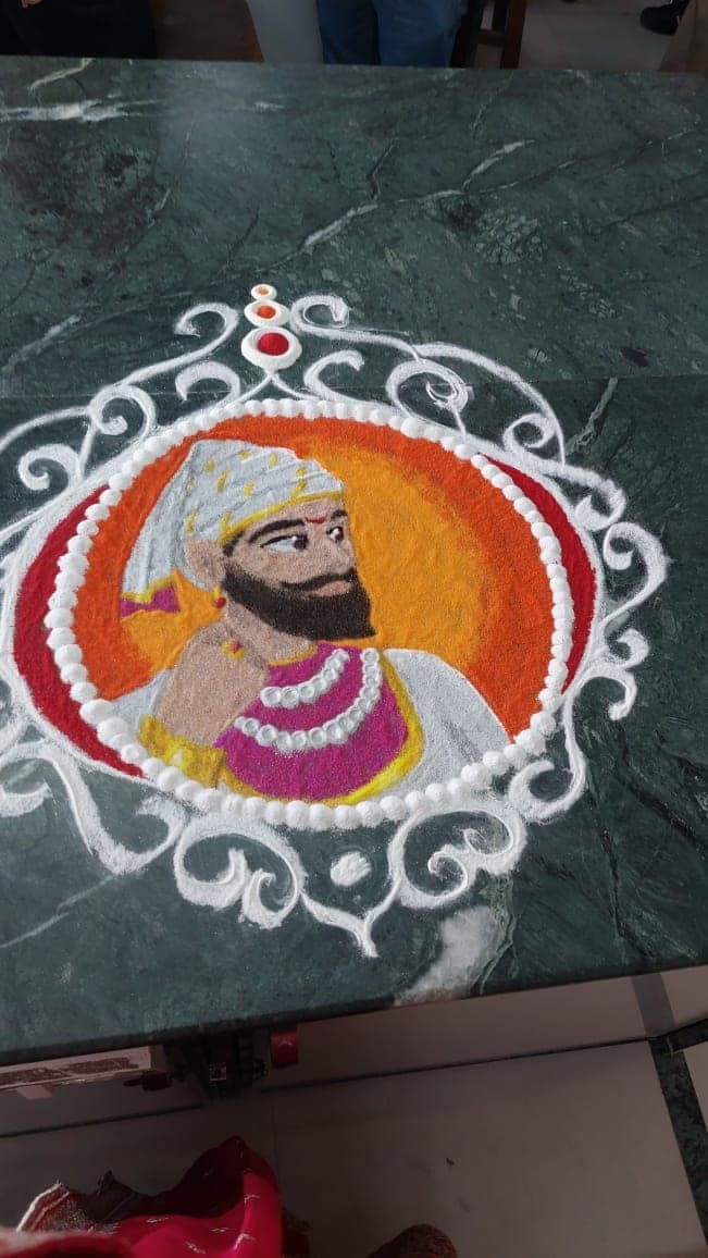 A rangoli made by students on the college floor.