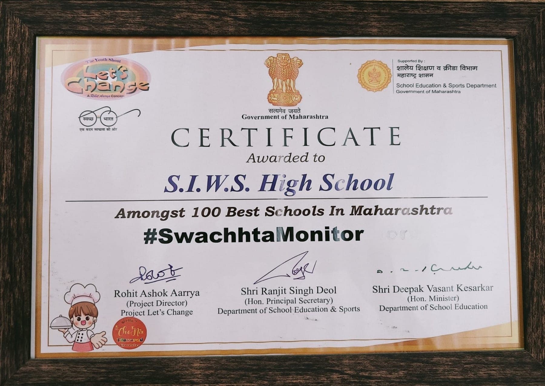 A framed Government of Maharashtra certificate on a wall, awarded to S.I.W.S. High School as amongst the 100 Best Schools in Maharashtra under #SwachhtaMonitor, signed by the Department of School Education and Sports.